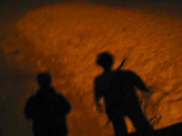Two silhouettes of guys on sand, Auckland, New Zealand
