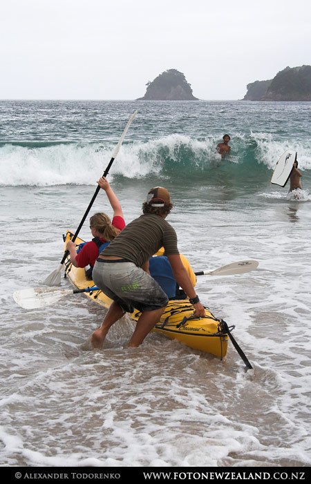 Launching a kayak Launching a kayak, Hahei Beach, New Zealand