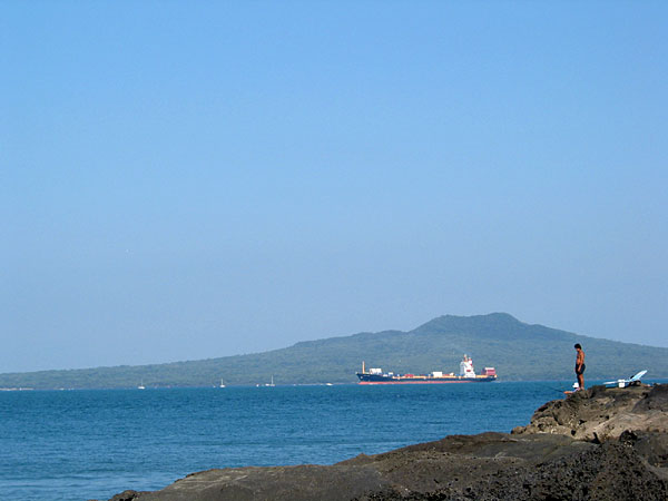 Fishermen, cargo ship and Rangitoto, Auckland, New Zealand