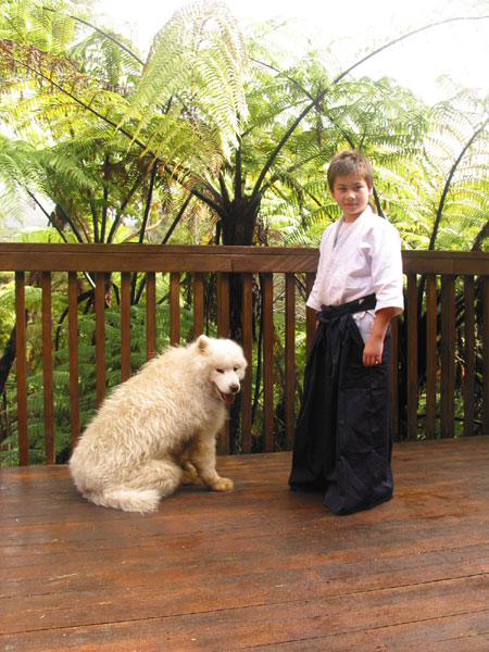An aikidoka boy with a dog, Coromandel, New Zealand