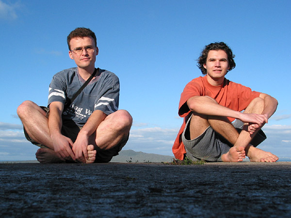 Two guys in shorts sitting legs crossed, Auckland, New Zealand