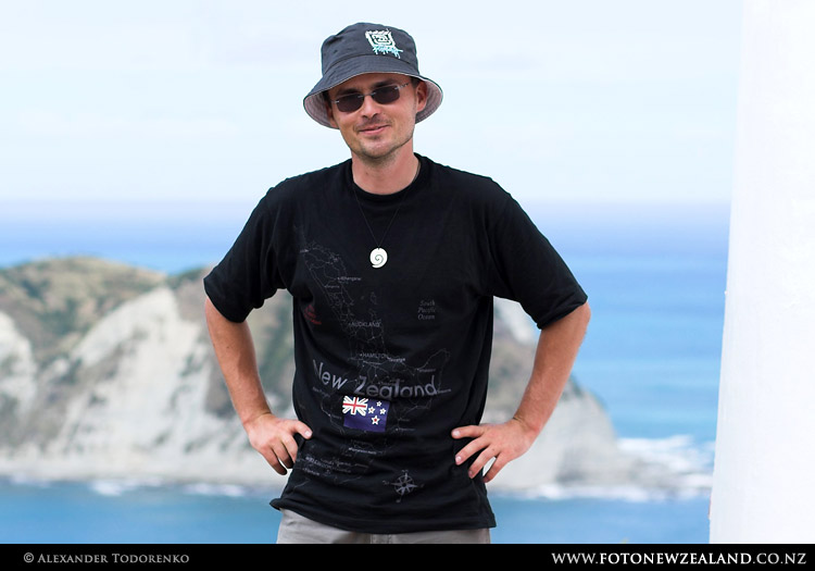 Alex next to the lighthouse, East Island in the background, East Cape, New Zealand
