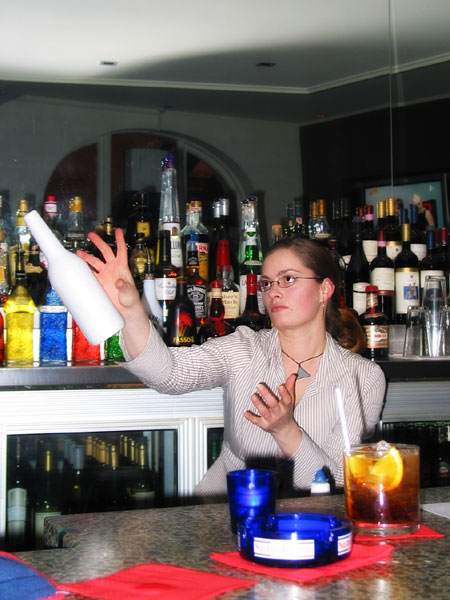 Girl bartender juggling bottles, Auckland, New Zealand