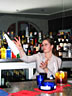 Girl bartender juggling bottles