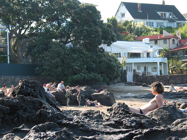 Sunbathing on the rocks by the sea, Auckland, New Zealand