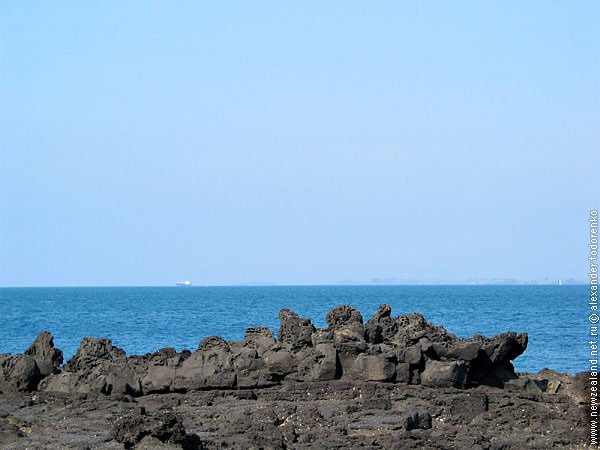 Black rocks and blue sea, Auckland, New Zealand