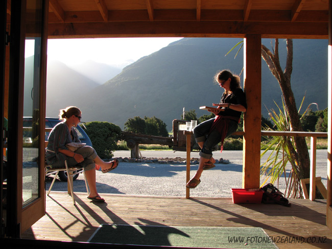 Two girls relaxing in the sun at the deck of Makarora Wilderness Resort