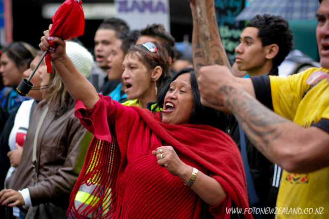 A Maori woman in red at the march of protest in Auckland