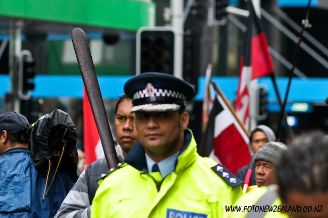 Maori protester with taiaha and policeman at Maori hikoi in Acukland